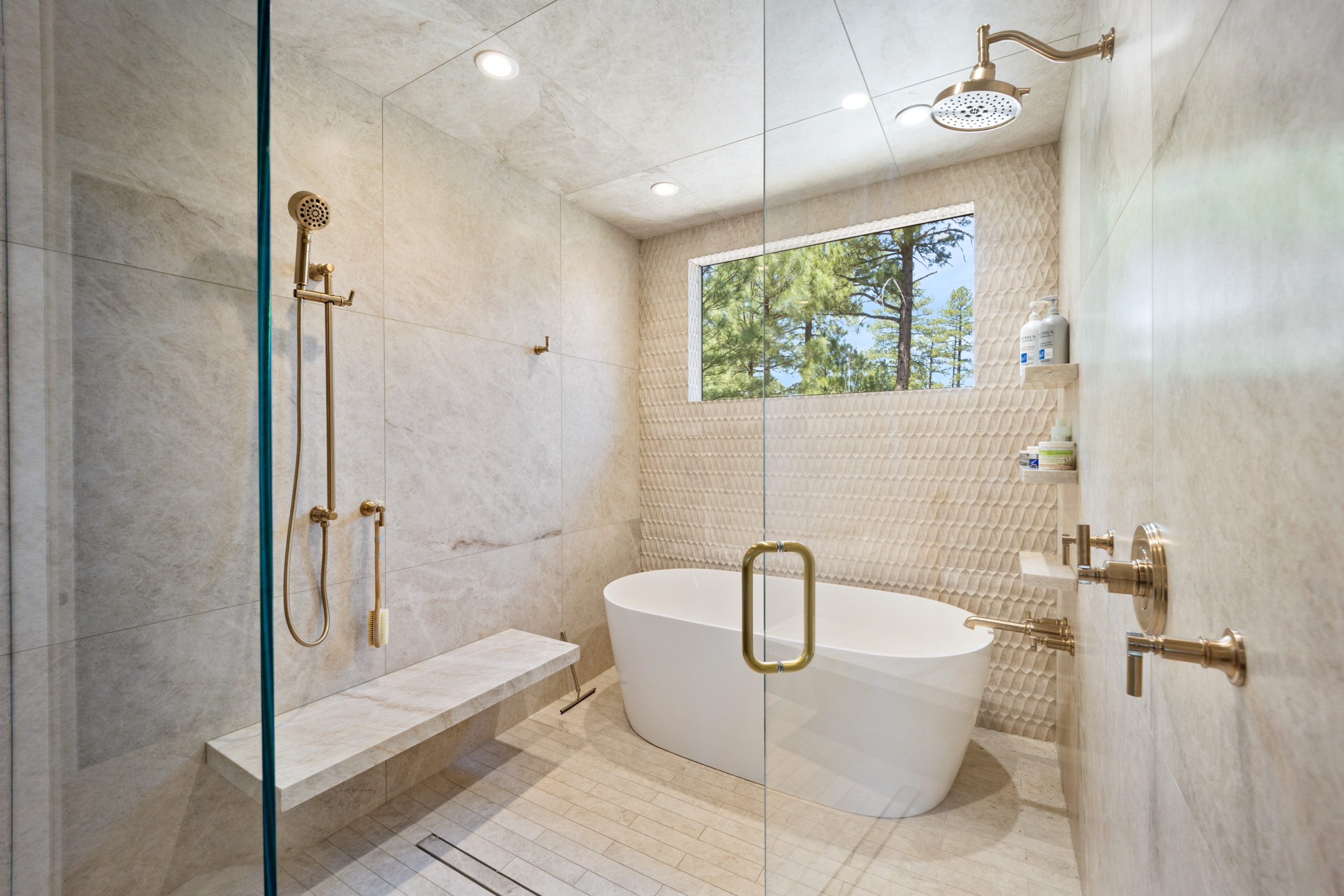 Primary bath with freestanding tub and brushed brass fixtures