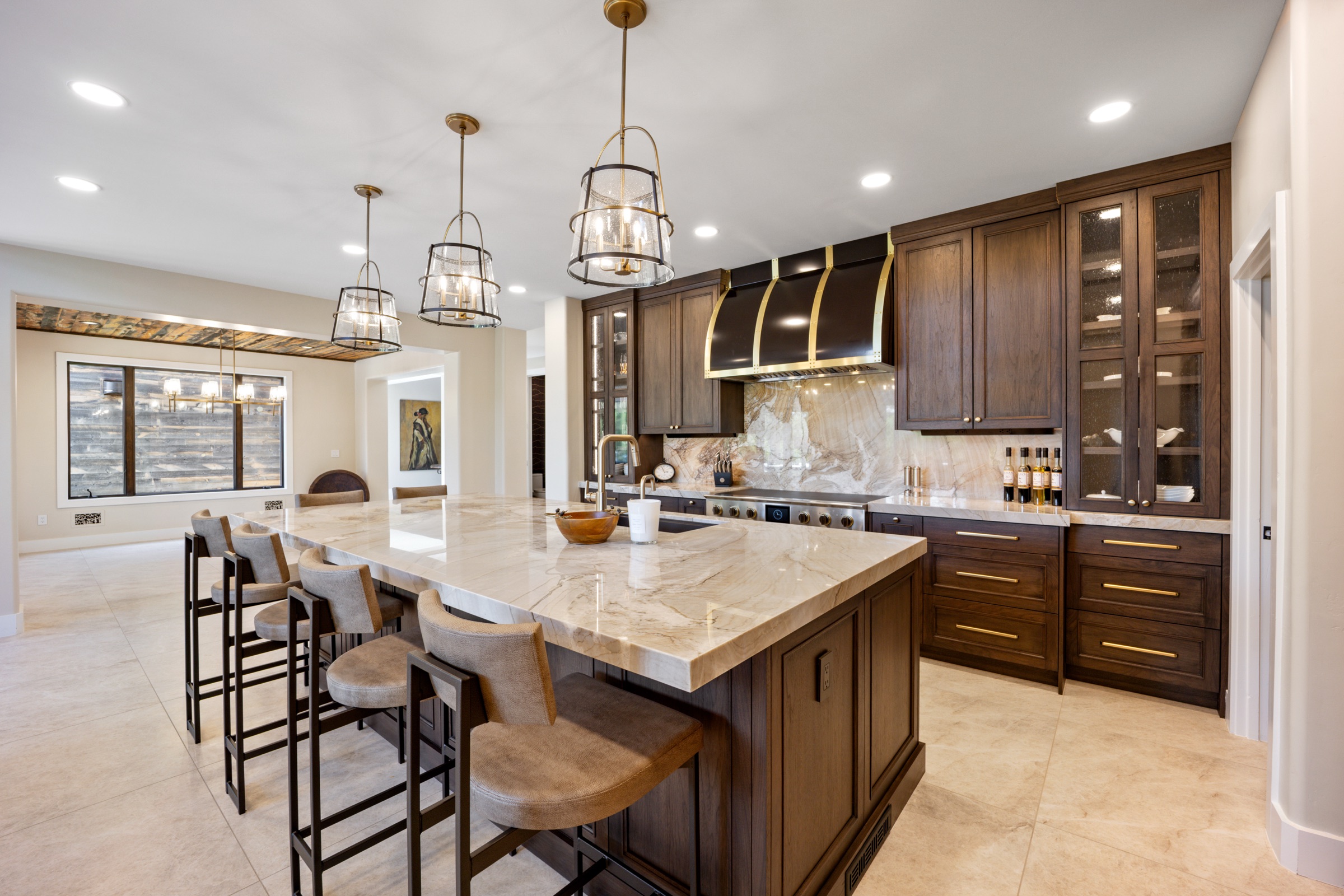 Kitchen island with quartzite counters and seeded-glass pendants