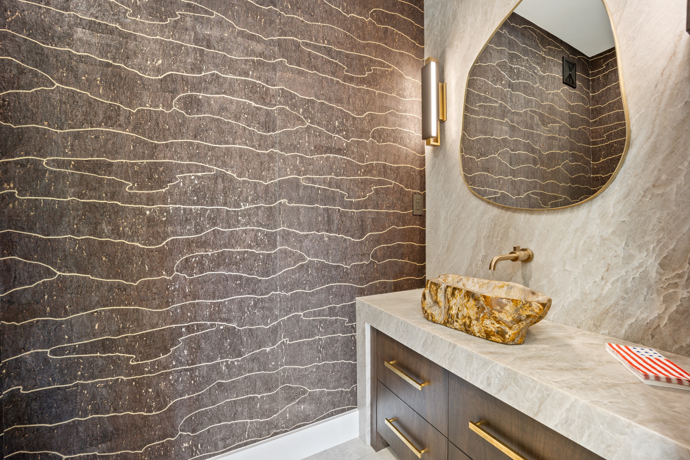 Powder room with cork wallcovering and petrified stone vessel sink